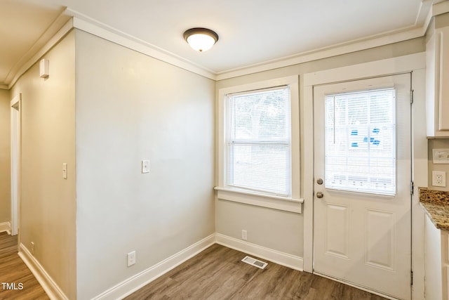 entryway featuring hardwood / wood-style flooring and crown molding