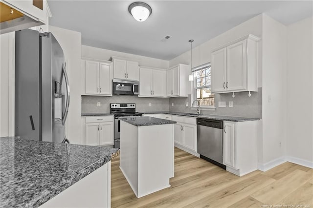 kitchen with appliances with stainless steel finishes and white cabinets