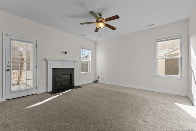 unfurnished living room with ceiling fan and carpet floors