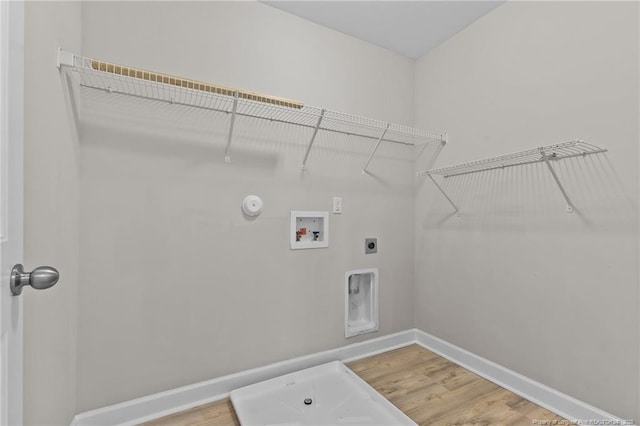 laundry area featuring gas dryer hookup, hardwood / wood-style floors, hookup for a washing machine, and hookup for an electric dryer