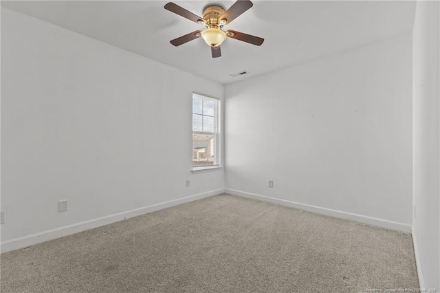 carpeted spare room with ceiling fan