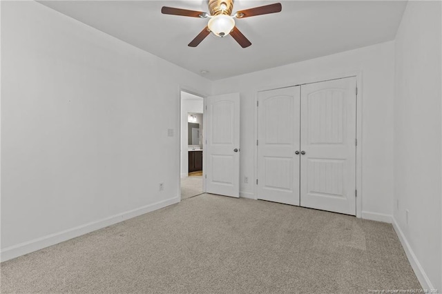 unfurnished bedroom with light colored carpet, a closet, and ceiling fan