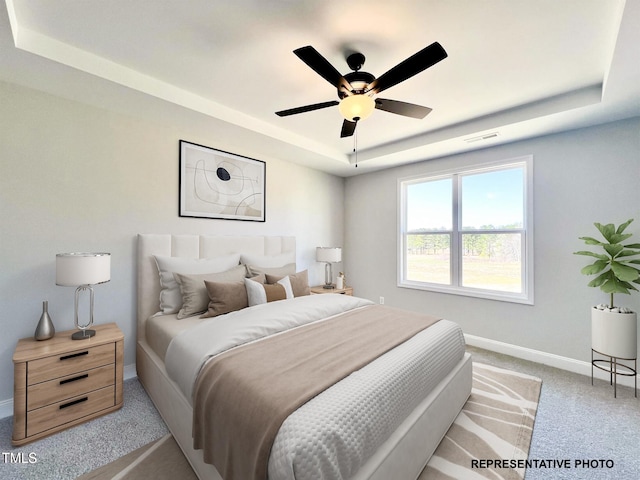 3963 Baileys Xrds Rd, Benson, NC 27504 - bedroom featuring a tray ceiling, light carpet, baseboards, and a ceiling fan