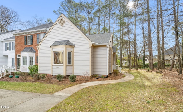 view of side of home with a yard