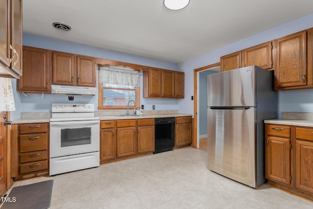 kitchen featuring black dishwasher, sink, stainless steel refrigerator, and electric stove