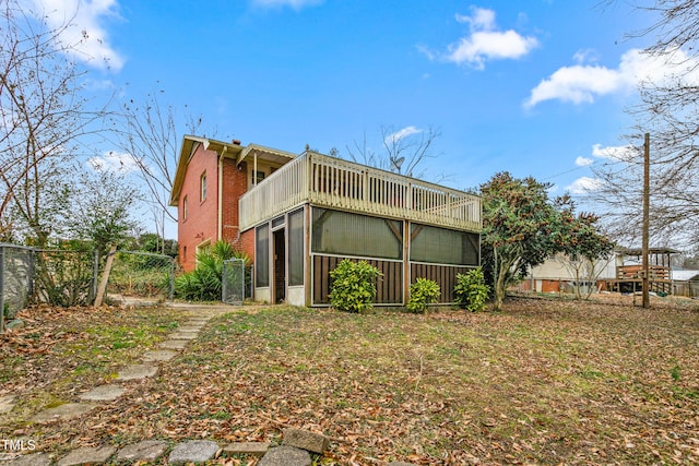 back of house featuring a sunroom