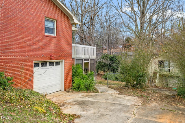 view of property exterior featuring a garage and a balcony