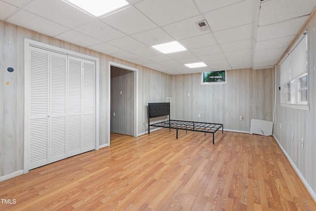 sitting room with light hardwood / wood-style flooring and a drop ceiling