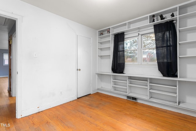 spare room featuring hardwood / wood-style flooring and a healthy amount of sunlight