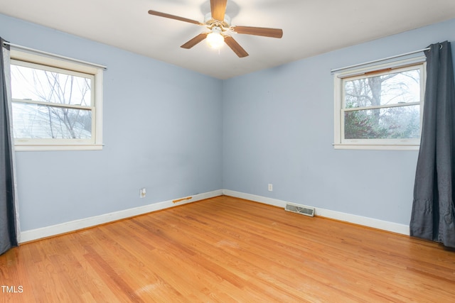 empty room with ceiling fan and light wood-type flooring