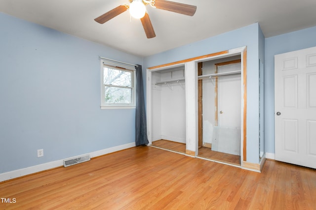 unfurnished bedroom featuring ceiling fan, light hardwood / wood-style floors, and a closet