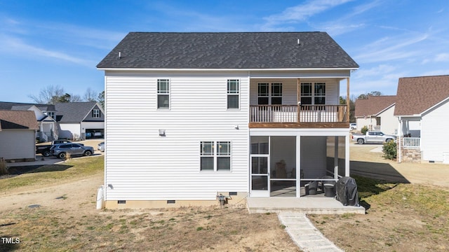 back of property with a sunroom and a balcony