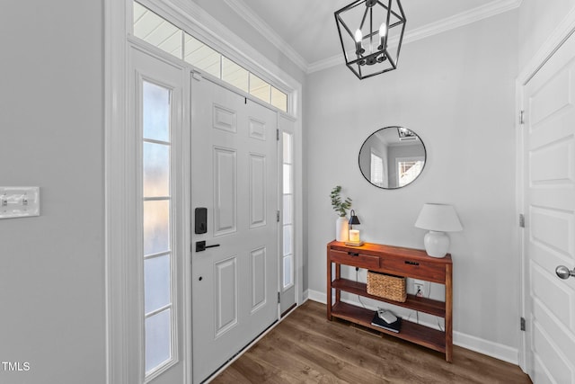 entryway with crown molding, dark wood-type flooring, and a chandelier