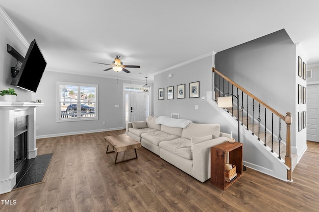 living room featuring crown molding, dark wood-type flooring, and ceiling fan