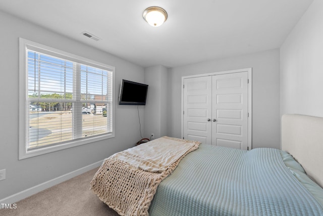 carpeted bedroom with a closet