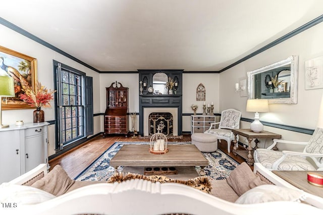 living room featuring ornamental molding, a fireplace, and hardwood / wood-style floors