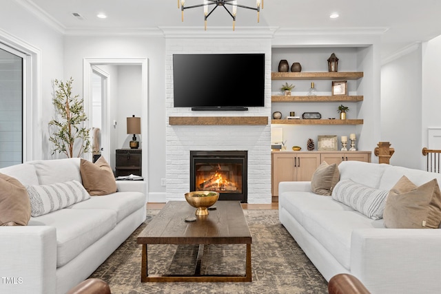 227 Beech Slope Ct, Chapel Hill, NC 27517 - living room with built in shelves, crown molding, an inviting chandelier, dark hardwood / wood-style flooring, and a fireplace