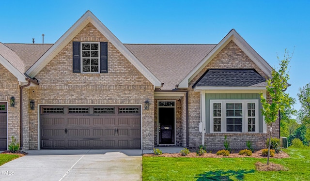 view of front of house with a garage and a front lawn