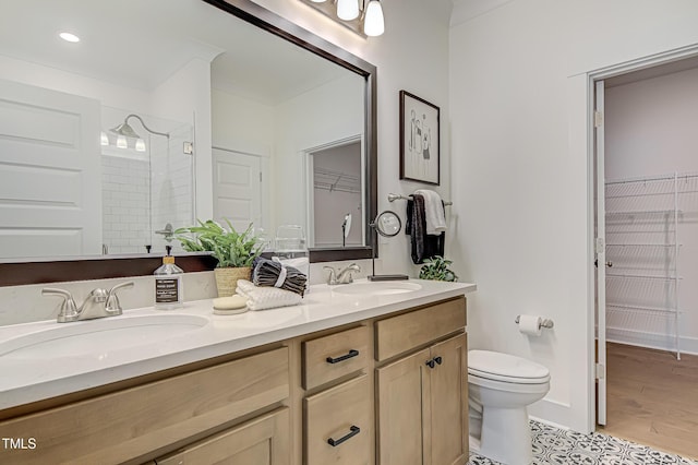 bathroom featuring vanity, wood-type flooring, toilet, and walk in shower