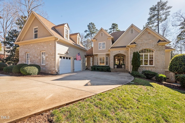 view of front of home with a garage and a front yard