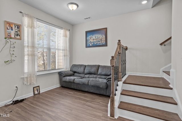 interior space featuring recessed lighting, visible vents, stairway, wood finished floors, and baseboards