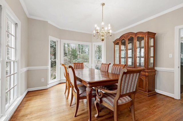 dining area featuring a healthy amount of sunlight, a chandelier, and light wood-type flooring