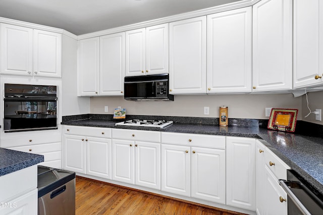 kitchen featuring white cabinetry, light hardwood / wood-style floors, and black appliances