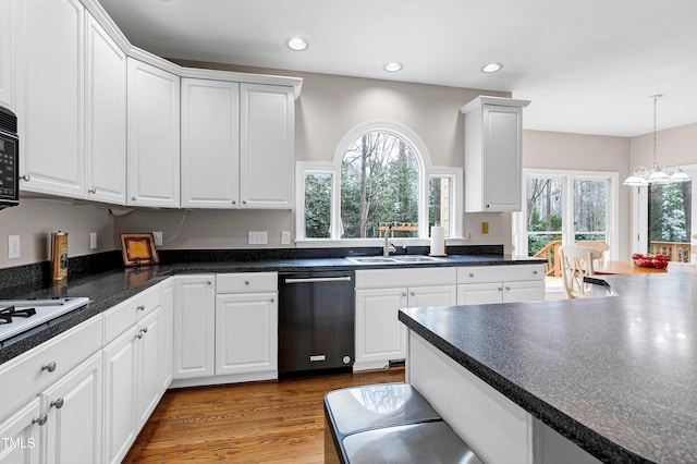 kitchen featuring white cabinets and black appliances