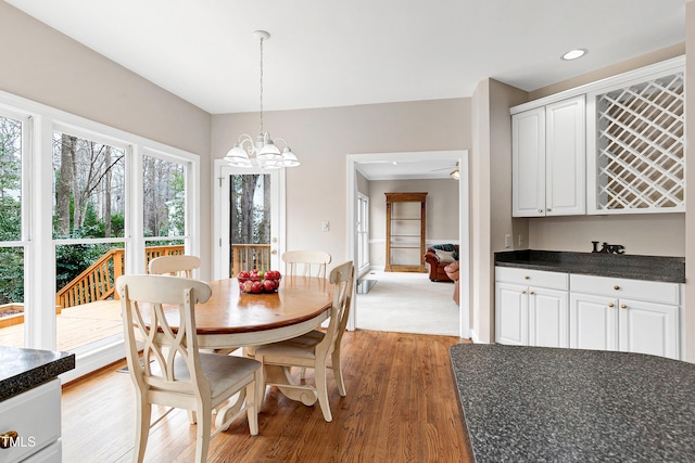 dining space featuring hardwood / wood-style flooring and a notable chandelier