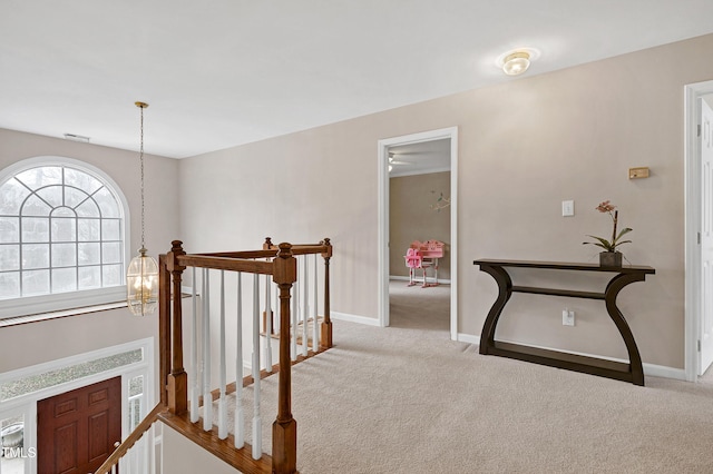 hallway featuring carpet floors and an inviting chandelier