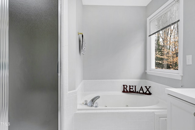 bathroom with vanity and shower with separate bathtub