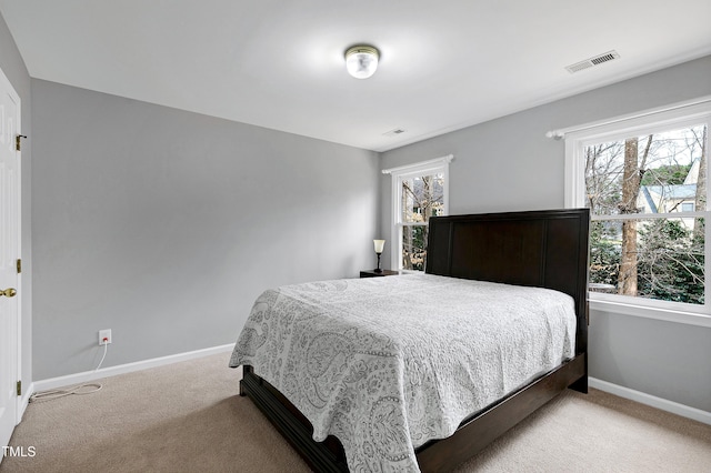 bedroom featuring light carpet