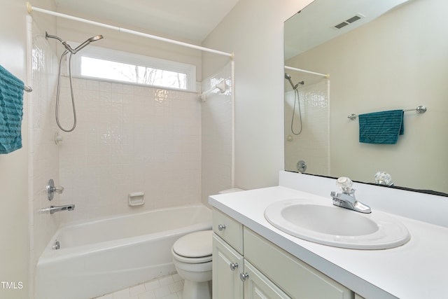 full bathroom with tiled shower / bath, vanity, toilet, and tile patterned flooring