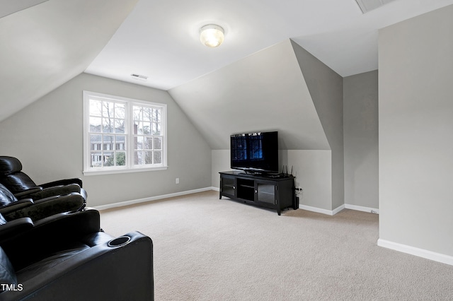 carpeted living room featuring lofted ceiling