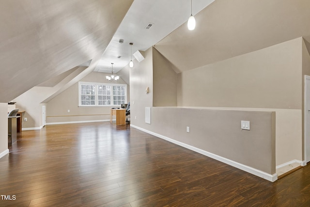 bonus room with lofted ceiling, a notable chandelier, and dark wood-type flooring