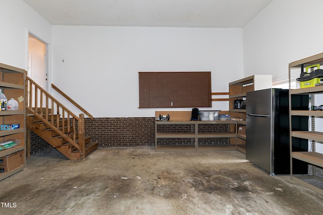 garage with stainless steel fridge