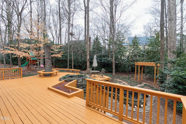 wooden terrace featuring a playground