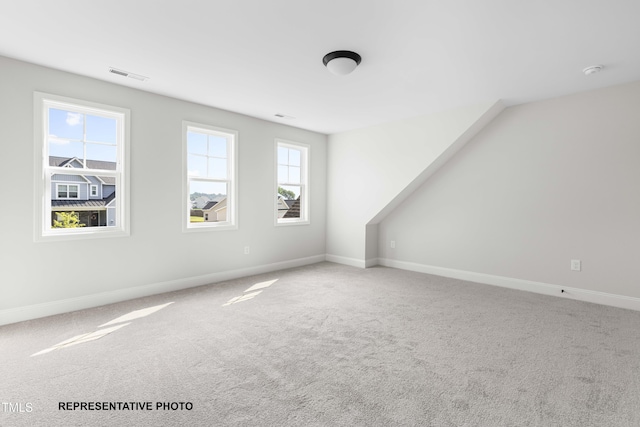 interior space featuring visible vents, carpet flooring, and baseboards