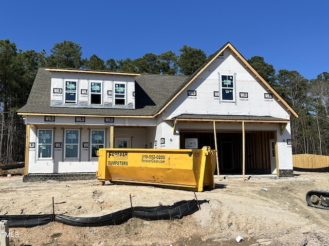 property under construction with roof with shingles