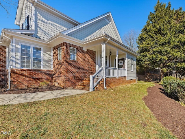 view of front of house with a front lawn and a porch