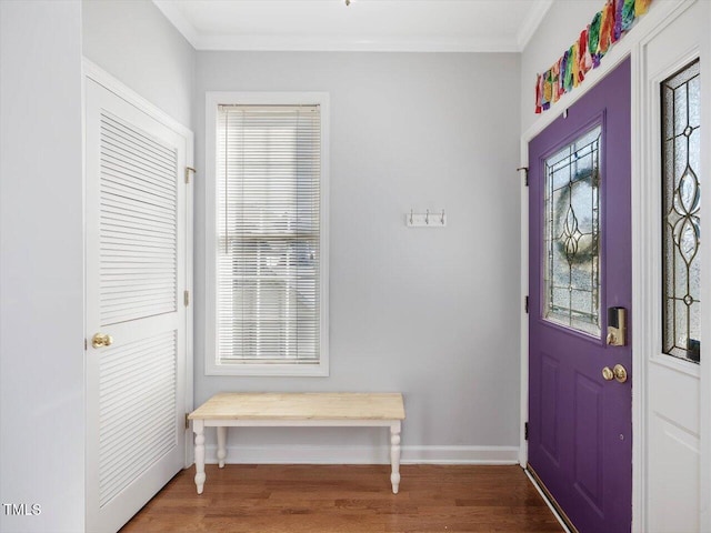 entrance foyer with hardwood / wood-style floors and ornamental molding