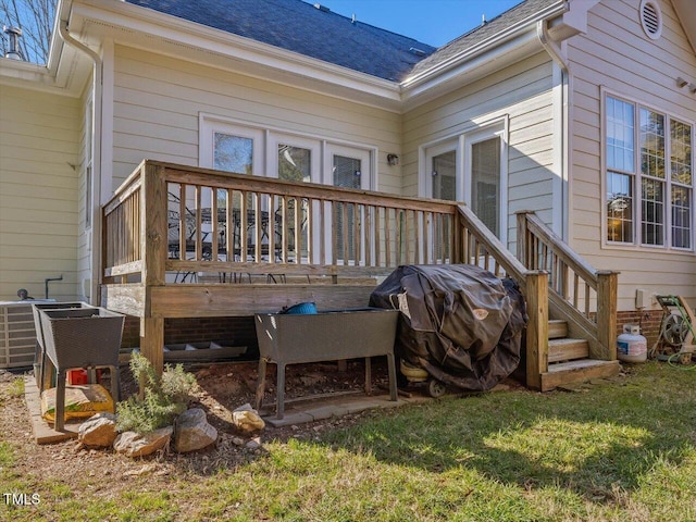 deck featuring a grill and a yard