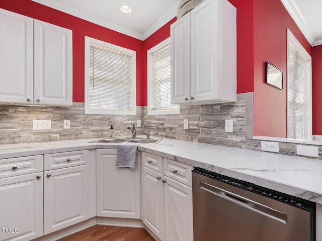 kitchen with sink, ornamental molding, white cabinets, and dishwasher