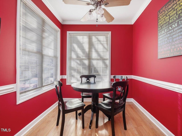 dining space featuring ornamental molding, light hardwood / wood-style floors, and ceiling fan