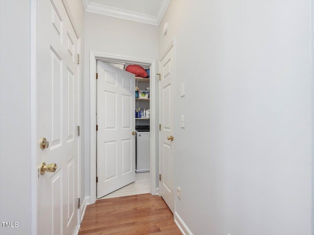 corridor featuring ornamental molding and light hardwood / wood-style floors