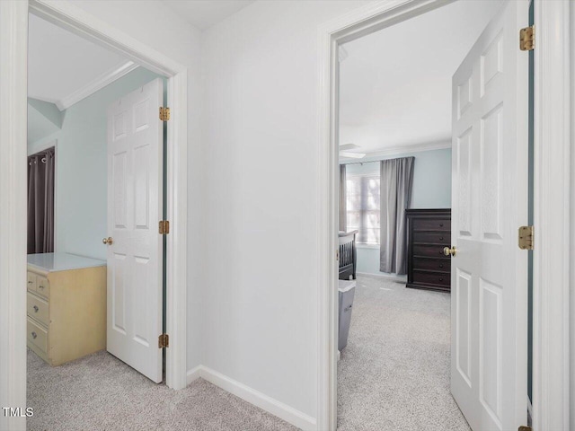 hall featuring ornamental molding and light carpet