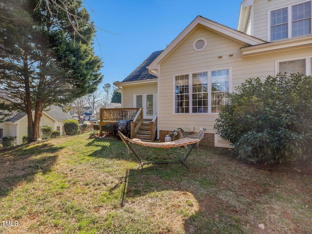 exterior space with a deck and a lawn