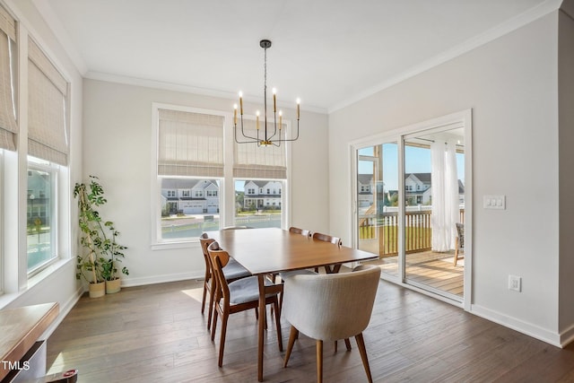 dining area featuring dark hardwood / wood-style flooring, a notable chandelier, and crown molding