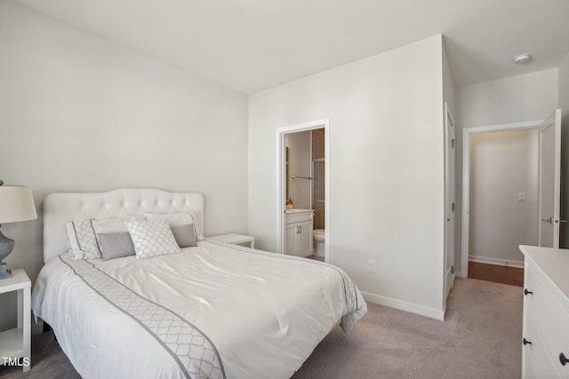 carpeted bedroom featuring connected bathroom