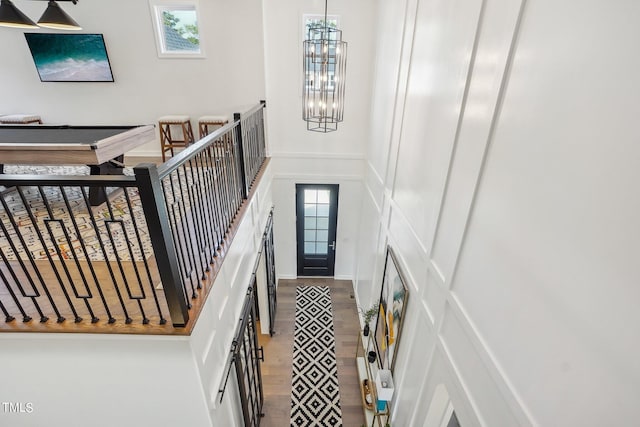 stairway with an inviting chandelier and a healthy amount of sunlight